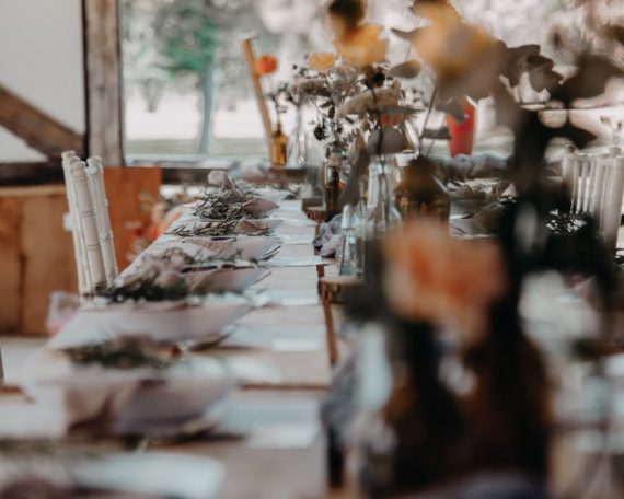 A beautifully set indoor table with floral decor, perfect for weddings or special events.